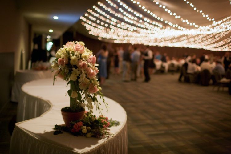 flower bouquet set to the side of a banquet hall