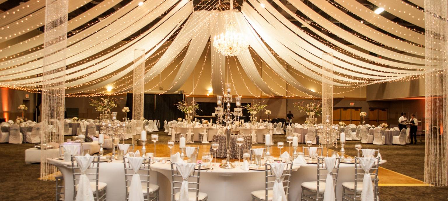 Formal wedding banquet set up with tableware and ceiling streamers